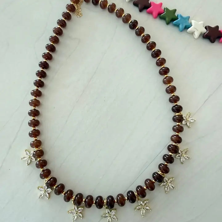 Beaded Bloom Necklace in Brown by Smith and Co. Design — chocolate brown glass beads with CZ floral charms close up