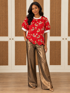 Sandra Top by Voy in red with a horse-and-lantern pattern, ivory neckline, puff sleeves, and scalloped hem, front view